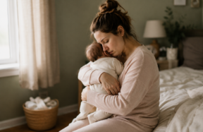 The image captures a quiet, authentic moment between a young mother and her baby