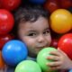 child playing in balls 80x80