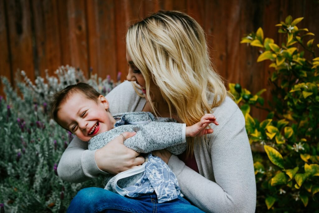Mother carrying her young son close in a moment of gentle parenting comfort